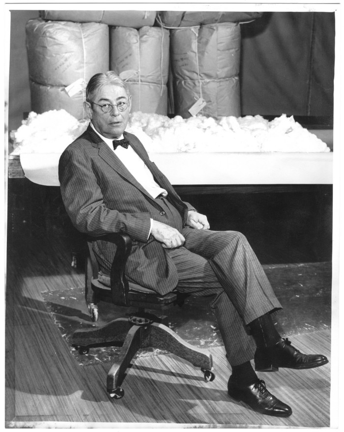 Mr. Lamar Fleming seated in the cotton sample room